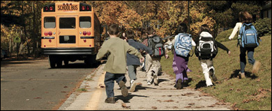 Photo: Children heading toward a school bus.