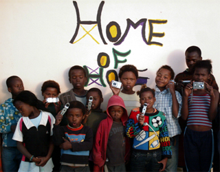 The “Picturing Hope” photography project taught basic photography skills to ten orphans who then documented their lives in Ncera Village, Eastern Cape, with images and English essays.