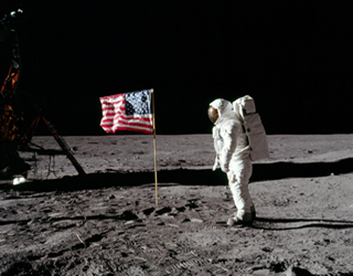 Two astronauts placed an American flag on the Moon’s surface during a television broadcast of the event.