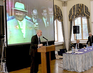Ambassador Beyrle speaking. On screen: Nikita Khrushchev and Richard Nixon.