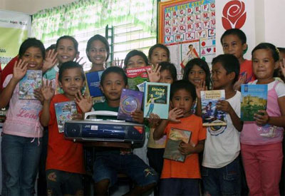 Schoolchildren from Lipao Elementary School in Datu Paglas, Maguindanao display some of the audio books, educational DVDs, and multimedia equipment they received from USAID’s EQuALLS2 and AMORE projects on July 29, 2009. 