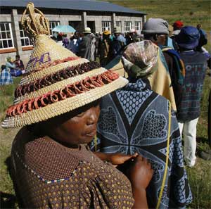 A woman wearing a traditional hat waits to vote in Likalaneng, Lesotho, February 17, 2007. [© AP Images]