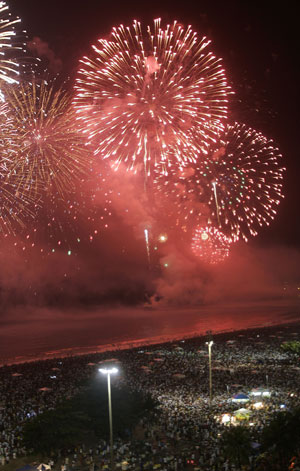 New Year's fireworks over a crowd of people at Copacabana beach, Rio de Janeiro, Brazil, January 1, 2006. [© AP Images]