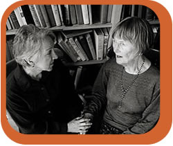 Two Women talking in a library