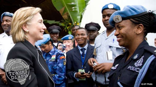Secretary Clinton with policewoman at Roberts International Airport, Monrovia, Aug. 13, 2009. [AP]