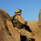 Soldier on side of hill in Afghanistan