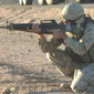 Soldier firing rifle