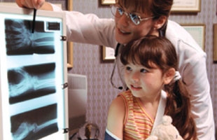 Woman and little girl looking at x-rays on a light box