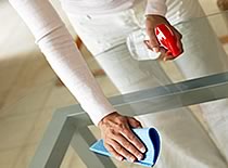 Photo of person cleaning glass surface