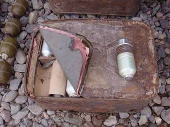 A close-up of one of the fifty 40-mm projectile grenades that were turned into Coalition forces under the Small Rewards Program, which rewards Afghans for turning in weapons. The cache was turned into Afghan National Security forces and Coalition forces in Shindand district, Herat Province, Jan. 28.