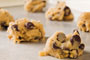 chocolate-chip cookie dough laid out on a silver baking tray.