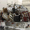 These three images show the progression of 'stacking' the Mars Science Laboratory rover and its descent stage in one of the Jet Propulsion Laboratory’s 'clean room.'  The final image shows the two pieces on top of each other.