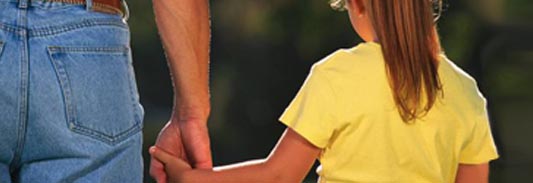 parent holding child hand while walking