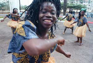 Cameroon dancers perform in front of the National Assembly in Yaounde, Cameroon, July 7, 1996. [© AP Images]