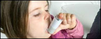 Child with inhaler.