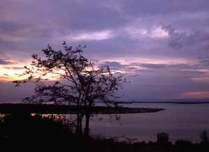 The sun sets over Lake George near Mweya, Uganda, April 5, 2000. [© AP Images]