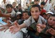 Pakistani children, displaced by the government's military offensive, plead for food at a United Nations facility. (Photo Reuters)
