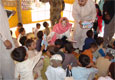 Jalozai, July 09, 2009 – U.S. Ambassador Anne W. Patterson hands out the first of 5,000 school kits provided by the United States to schoolchildren during a visit to Jalozai IDP Camp Complex in Nowshera District.