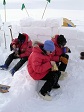 Three U.S. Antarctic Program participants enjoy their rehydrated dinners during Snowcraft Training, near McMurdo Station.