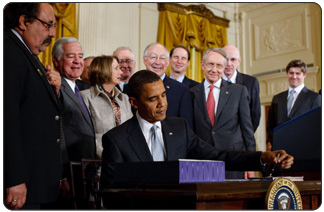 President Obama signs the Omnibus Public Lands Management Act of 2009 into law on March 30 at the White House.  Also pictured from left to right: Rep. Raúl Grijalva (D-AZ), Rep. Nick Rahall (D-WV), Speaker of the House Nancy Pelosi (D-CA), Rep. Buck McKeon (R-CA), Secretary of the Interior Ken Salazar, Senate Majority Leader Harry Reid (D-NV), Senator Ron Wyden (D-OR), and Senator Robert Bennett (R-UT) (White House Photo, 3/30/09, Chuck Kennedy) 