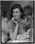 Destitute peapickers in California; a 32 year old mother of seven children [mother and two children on either side of her, children's backs to camera]