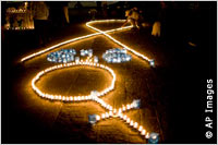 A man in Guatemala lights one of many candles commemorating International Day for the Elimination of Violence against Women in 2008.