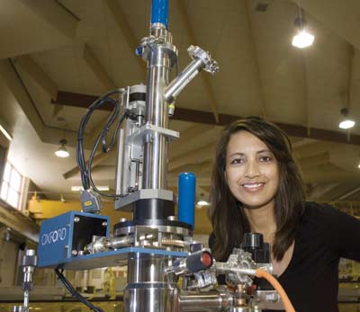 Leilani Conradson sets up a displex for Lujan Center users. The apparatus cools samples in a neutron scattering experiment to cryogenic temperatures near absolute zero. Photo by Sandra Valdez