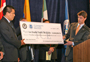 ICE Assistant Secretary John Morton presents a check to Mexican officials 