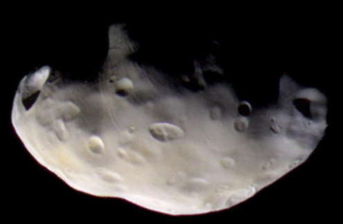 Color image of dusty potato-shaped moon Pandora.