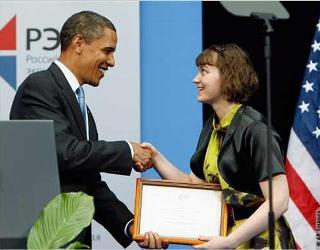 President Obama hands a diploma to the NES top of the class of 2009, Oksana Sytnova