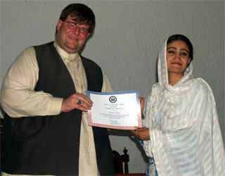 Lahore, June 3, 2009 - U.S. Consulate's Principal Officer Bryan Hunt awards certificate to a participant of the Survey of American History at Lahore Museum Auditorium.