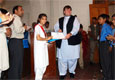Lahore, April 22, 2009 – U.S. Consulate Principal Officer Bryan Hunt presenting a shield, certificate and a gift of books to one of the prize winners at the inauguration of a poster exhibit titled “Lahore – My City”.