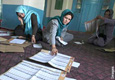 Afghan election workers count ballots at a polling station (AP Images)