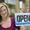 Business owner holding an open sign