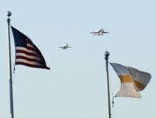Framed by the flags fluttering over the outfield fence, NASA Dryden T-38 and F/A-18 aircraft performed a low-level flyby past Clear Channel Stadium in Lancaster, Calif., the evening of Aug. 15 as part of the Lancaster JetHawks Aerospace Appreciation Night.