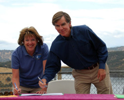 Susan Moore, Field Supervisor, Sacramento Fish & Wildlife Office, and Richard G. Sykes, Manager of Natural Resources for East Bay Municipal Utility District, sign a Safe Harbor Agreement at the Pardee Reservoir in Amador County