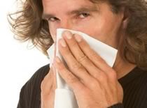 Photo of man covering face with tissue