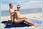 Girl Putting Sunscreen On Mother