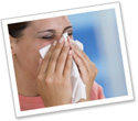 A woman covering a sneeze with a tissue.