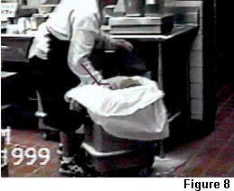 Kitchen worker scooping ingredients with flexed wrist