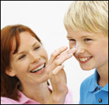 Photo: A mother applying sunscreen on her son.