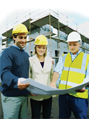 Three people in hardhats looking at construction plans