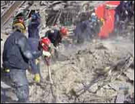 Rescue workers looking through debris