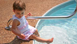 Photo - child siiting on the edge of the pool