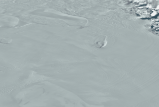 The MODIS Mosaic of Antarctica reveals the dynamic crevasses and ice flows in the Ross Ice Shelf.