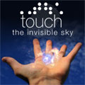 A Hubble image of the Homunculus Nebula floats above an open hand. Above are the words 'Touch the Invisible Sky' and the Braille symbols for 'touch' overlayed on a finger print. Credit: Jenny Mottar, graphic artist.