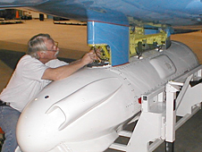NASA technician Gary Carlson removes the Ka-band waveguide before exchanging the Ka-band radar pod for the L-band pod mounted underneath NASA’s G-III research aircraft.