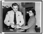 a woman being fingerprinted