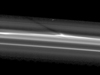 Cassini spies a shadow cast by a vertically extended structure or object in the F ring in this image
