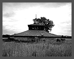 View of a thirteen-sided log Indian dance lodge